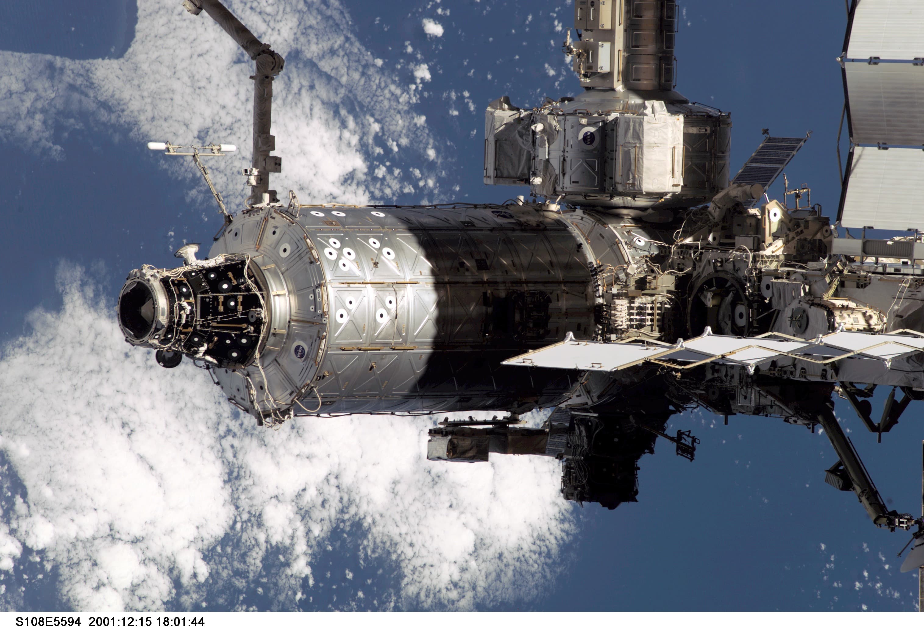 Destiny laboratory and neighbouring space-station structures above blue Earth and white clouds