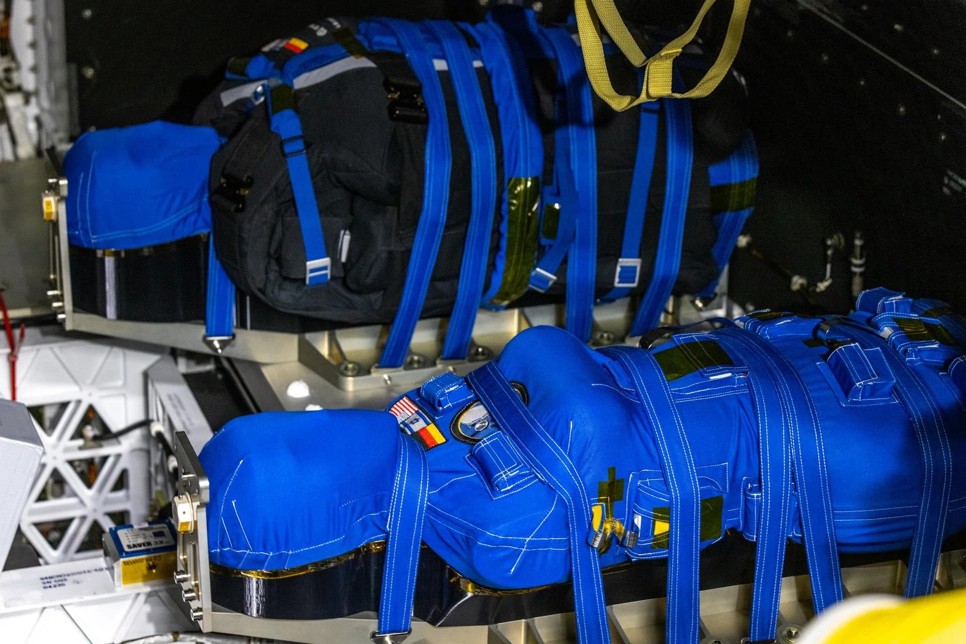 Two blue instrumented radiation manikins secured in seats inside the Artemis I Orion crew module
