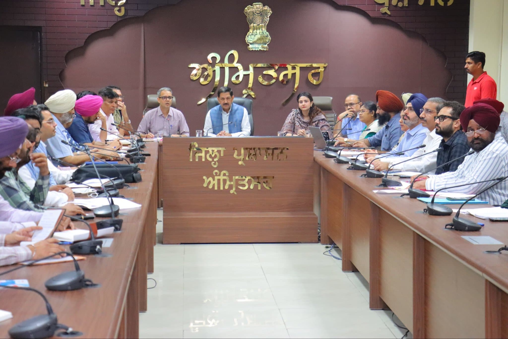 Officials seated around a conference table in Amritsar during the farm-fire prevention review