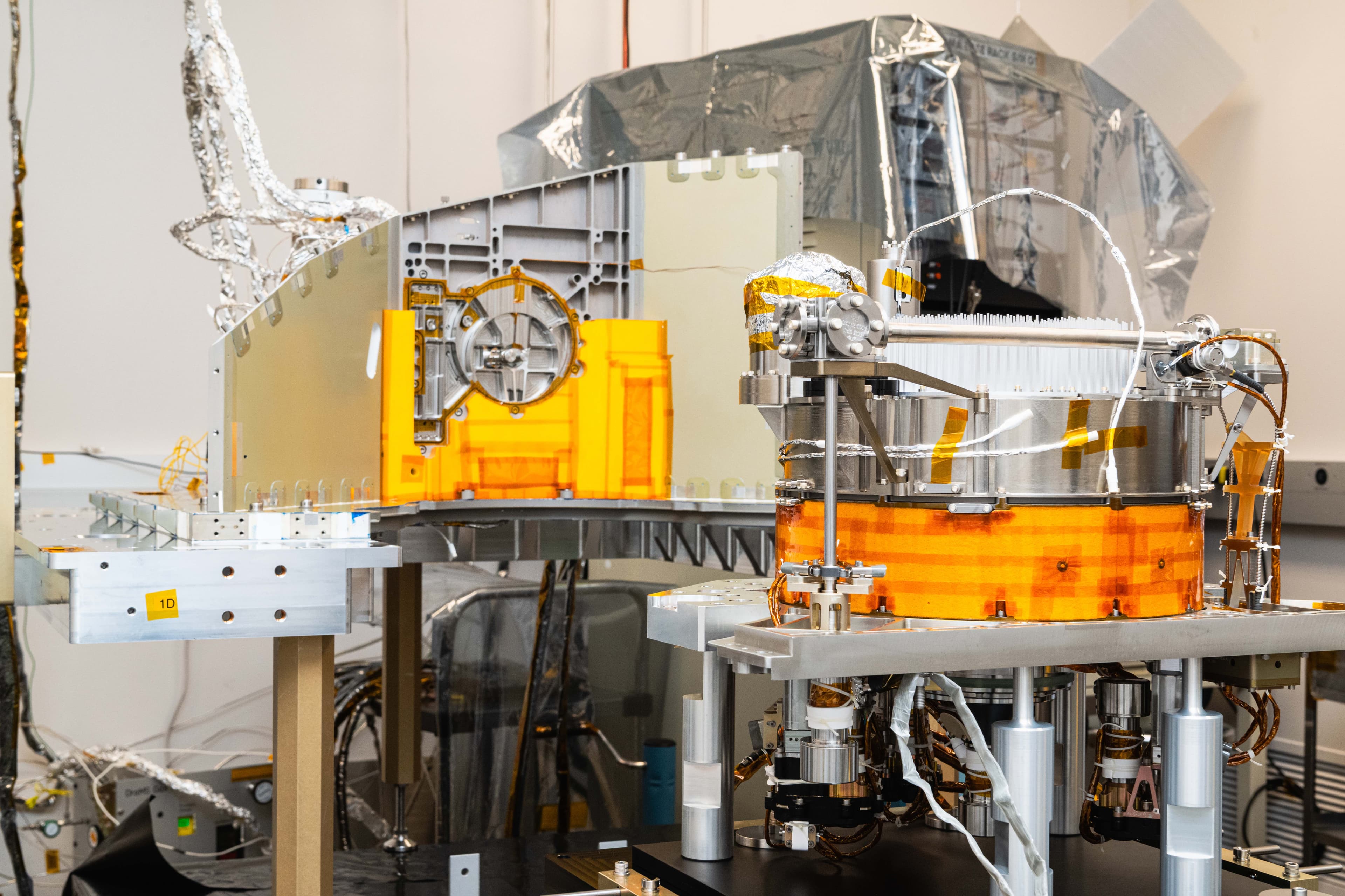 Metallic instrument assemblies, orange protective panels and silver insulation on laboratory supports