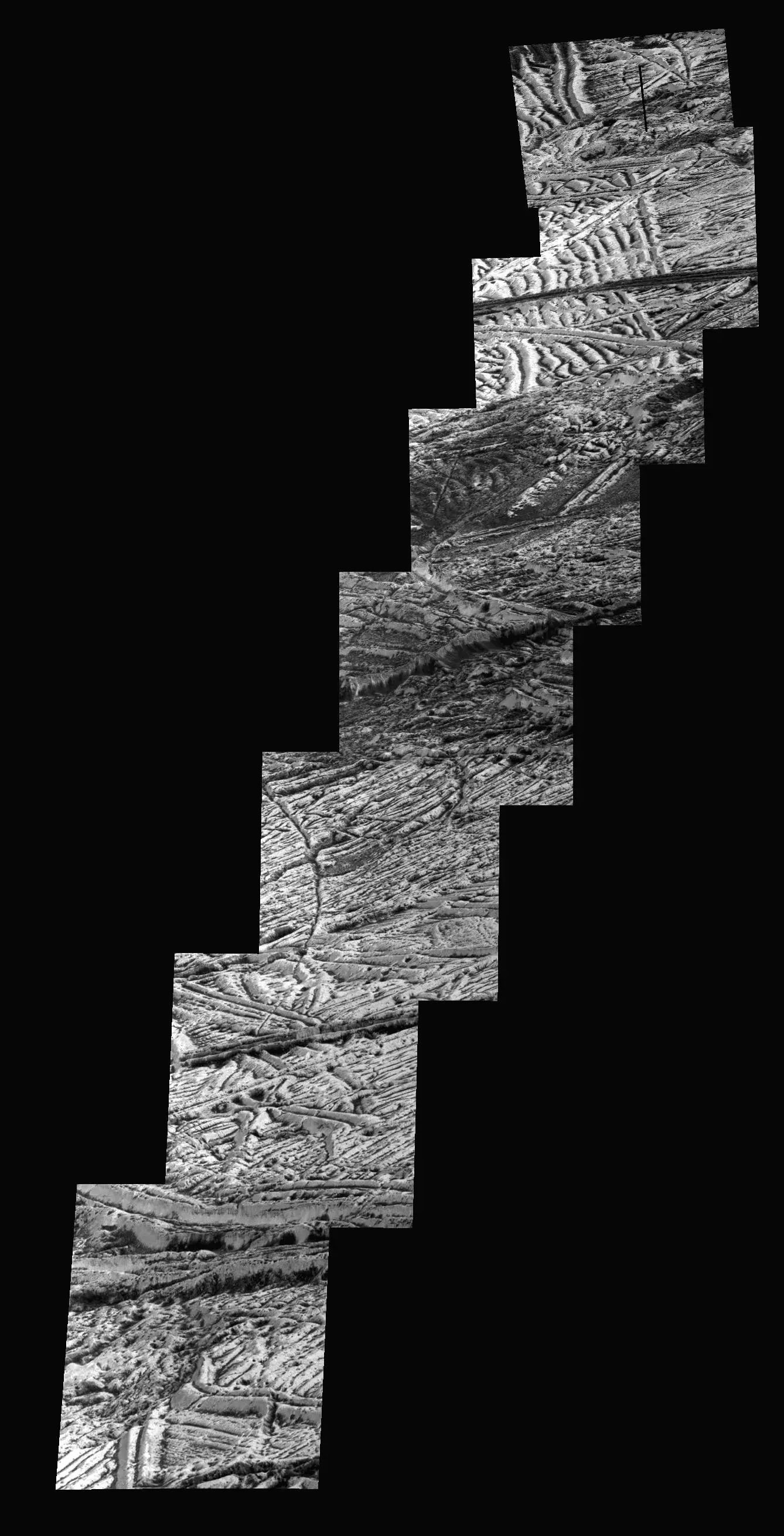 Black-and-white Galileo mosaic showing overlapping high-resolution strips of fractured and ridged ice on Europa