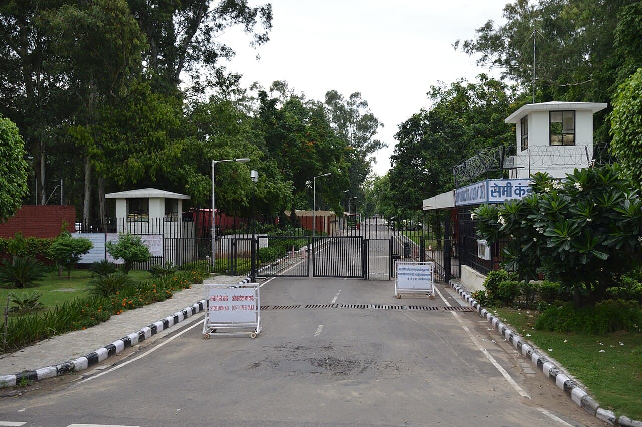 Tree-lined entrance road and guarded gates at the Semiconductor Laboratory in Mohali