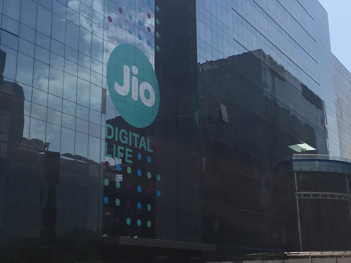 Glass office facade with a large Jio sign at Reliance Corporate Park in Navi Mumbai