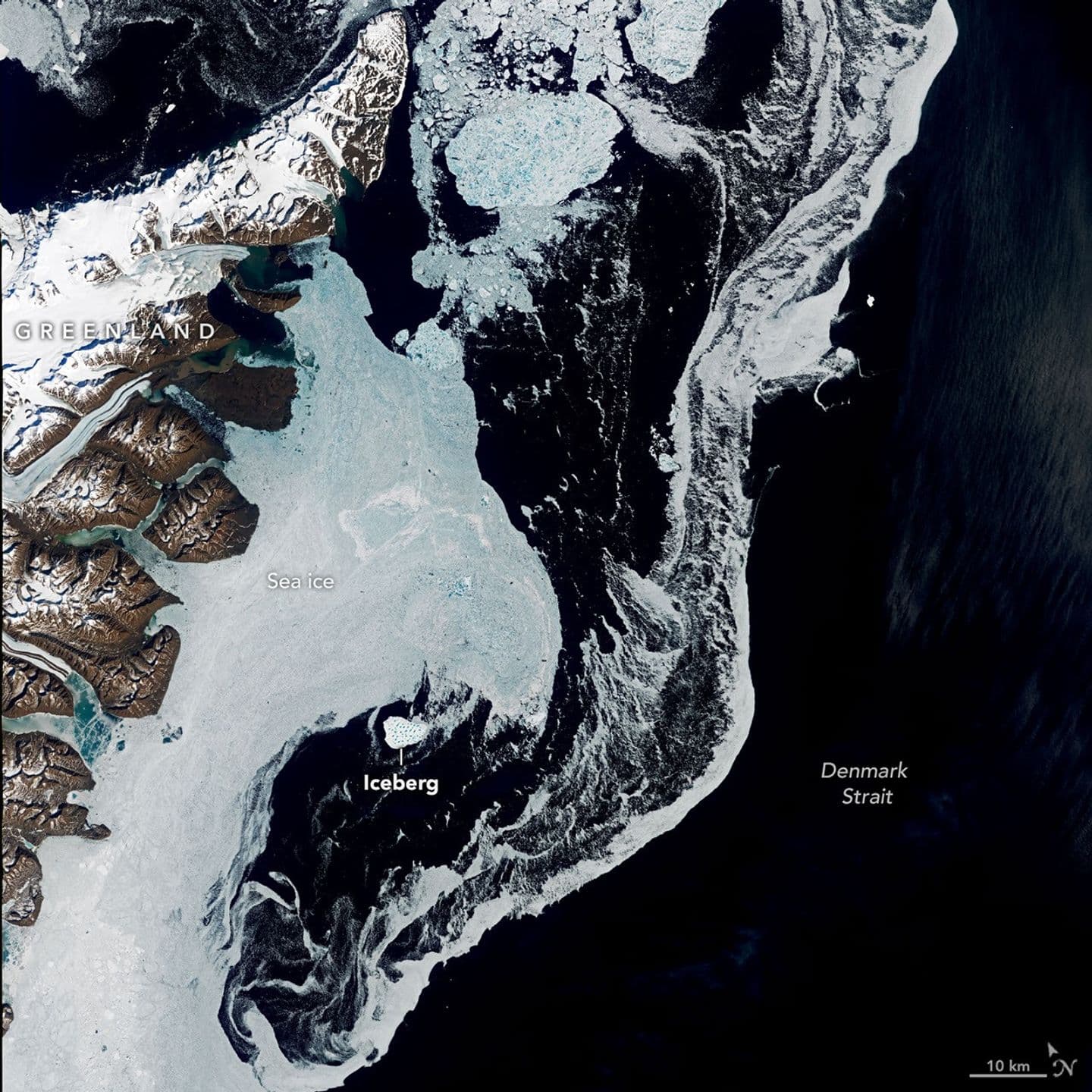 Annotated Landsat 9 view of east Greenland and Denmark Strait, with the iceberg and surrounding sea ice labelled