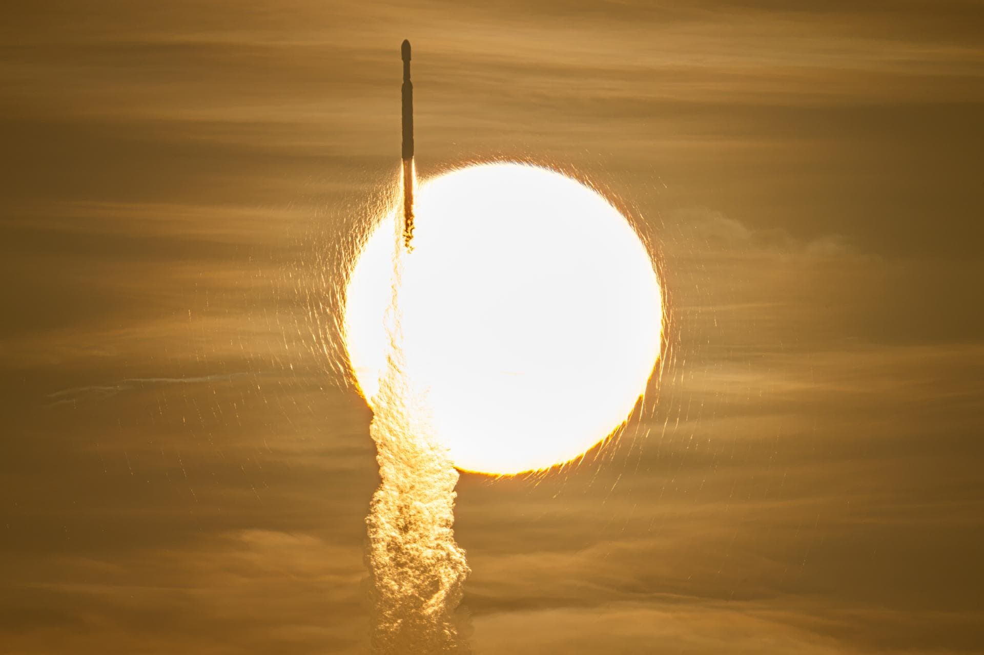 A SpaceX Falcon Heavy rocket carrying NASA's Nancy Grace Roman Space Telescope rises in front of the Sun during launch from Kennedy Space Center