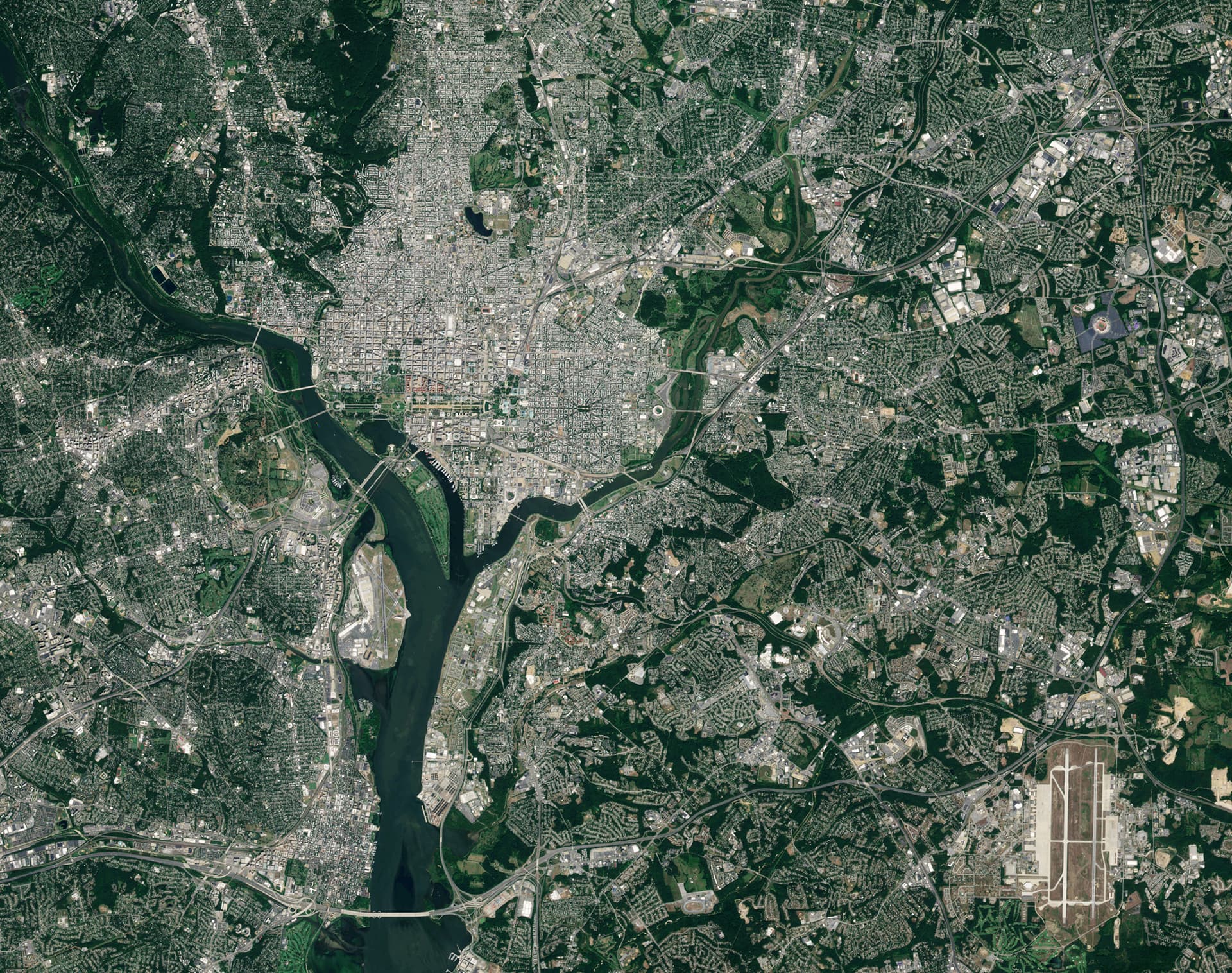 Satellite view of Washington, DC, with the Potomac River winding through the city and surrounding green suburbs